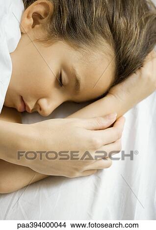 Girl sleeping, mother's hand on arm View Large Photo Image Picture - Girl sleeping, mother's hand on arm. Fotosearch