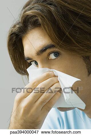 Stock Photo - Man wiping nose. Fotosearch