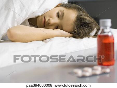 Stock Photo - Sick child asleep in bed. Fotosearch