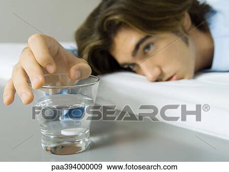 Sick man preparing effervescent medicine View Large Photo Image Stock Photo - Sick man preparing effervescent medicine. Fotosearch