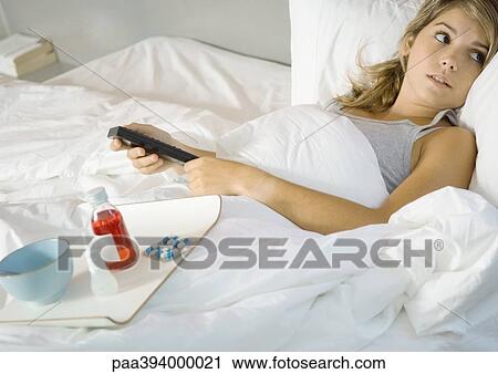Young woman lying in bed View Large Photo Image Stock Image - Young woman lying in bed. Fotosearch