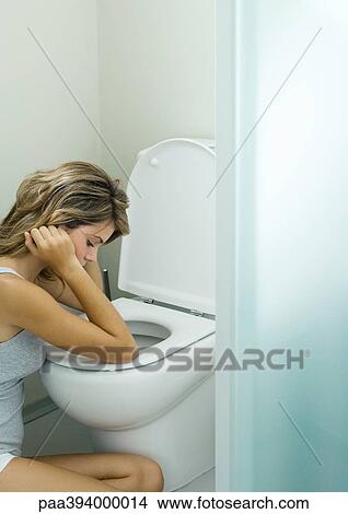Young woman sitting next to toilet View Large Photo Image Picture - Young woman sitting next to toilet. Fotosearch