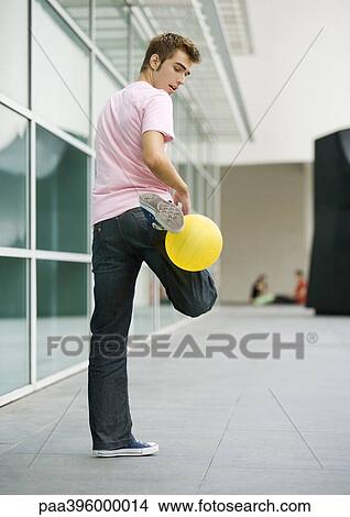 Picture - Teen boy playing with ball. Fotosearch