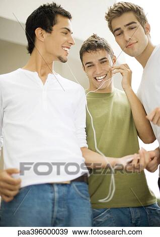 Teen boys listening to earphones View Large Photo Image Stock Photo - Teen boys listening to earphones. Fotosearch