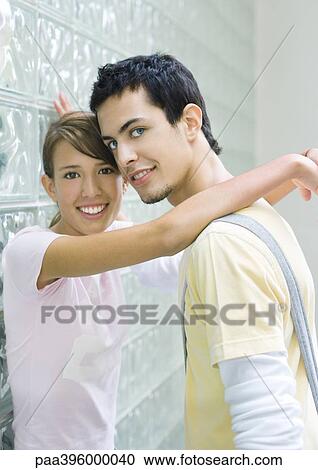 Teen couple leaning against wall View Large Photo Image Stock Image - Teen couple leaning against wall. Fotosearch