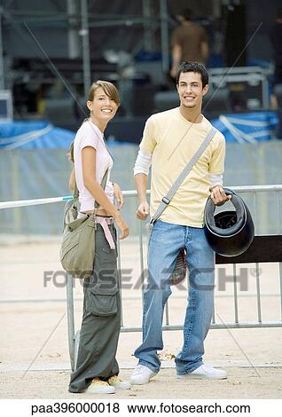 Teen couple standing, smiling at camera View Large Photo Image Stock Photo - Teen couple standing, smiling at camera. Fotosearch