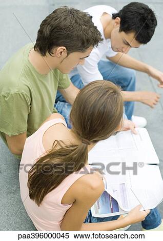 Teen friends, girl holding newspaper View Large Photo Image Stock Photography - Teen friends, girl holding newspaper. Fotosearch