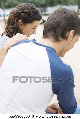 Stock Photograph - Teen friends sitting outdoors. Fotosearch