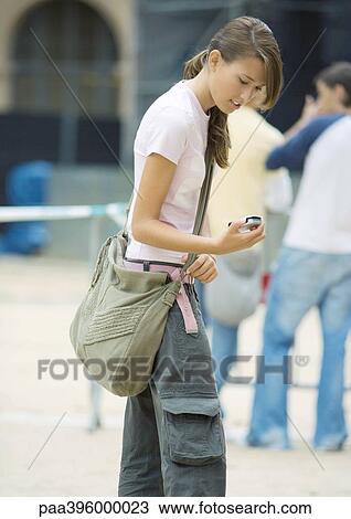 Teen girl looking at cell phone View Large Photo Image Stock Image - Teen girl looking at cell phone. Fotosearch