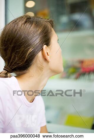Teen girl looking at shop window View Large Photo Image Stock Photo - Teen girl looking at shop window. Fotosearch