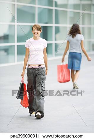 Teen girls carrying shopping bags View Large Photo Image Stock Image - Teen girls carrying shopping bags. Fotosearch