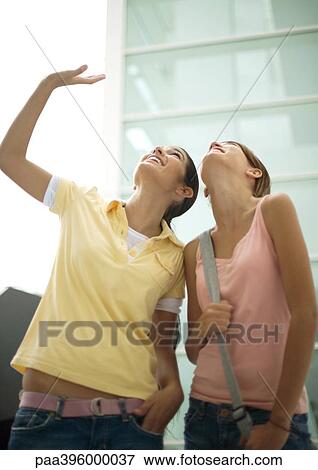 Teen girls looking up View Large Photo Image Stock Photo - Teen girls looking up. Fotosearch