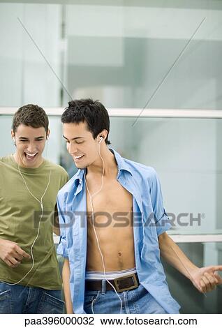 Teen males listening to earphones, playing air guitar View Large Photo Image Stock Image - Teen males listening to earphones, playing air guitar. Fotosearch