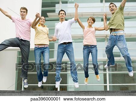 Teens holding hands and jumping in the air View Large Photo Image Stock Image - Teens holding hands and jumping in the air. Fotosearch