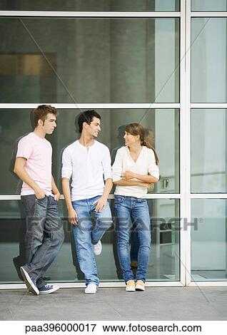 Teens leaning against wall, talking View Large Photo Image Stock Photo - Teens leaning against wall, talking. Fotosearch