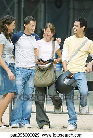 Teens standing outdoors, talking View Large Photo Image Stock Photo - Teens standing outdoors, talking. Fotosearch