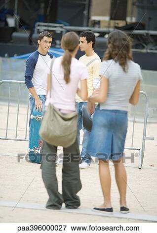 Teens, two teen girls facing two teen boys, rear view View Large Photo Image Stock Photo - Teens, two teen girls facing two teen boys, rear view. Fotosearch