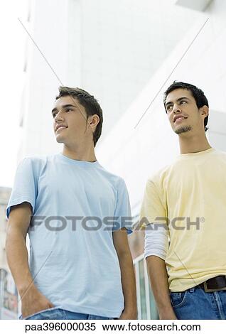 Two teen boys standing, looking out of frame View Large Photo Image Stock Photography - Two teen boys standing, looking out of frame. Fotosearch