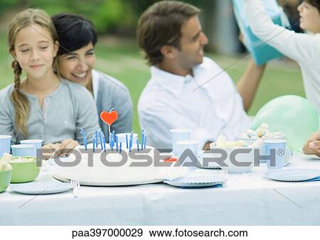 Stock Photo - Family having outdoor birthday party. Fotosearch