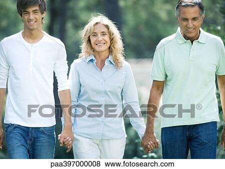 Stock Photo - Mature couple holding hands with teenage grandson. Fotosearch