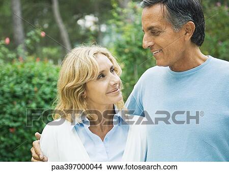 Picture - Mature couple, smiling at each other. Fotosearch