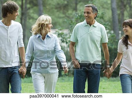 Mature couple walking, holding hands with teen grandchildren View Large Photo Image Stock Image - Mature couple walking, holding hands with teen grandchildren. Fotosearch