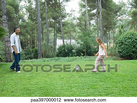 Mature man playing soccer with granddaughter View Large Photo Image Stock Image - Mature man playing soccer with granddaughter. Fotosearch