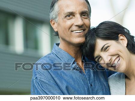 Stock Image - Mature man with adult daughter. Fotosearch
