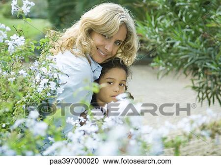 Stock Image - Mature woman with granddaughter. Fotosearch
