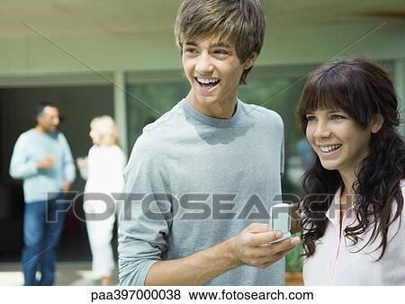 Stock Photo - Teenage boy and girl, laughing. Fotosearch