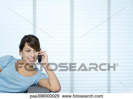 Young woman using wireless phone View Large Photo Image Stock Photo - Young woman using wireless phone. Fotosearch
