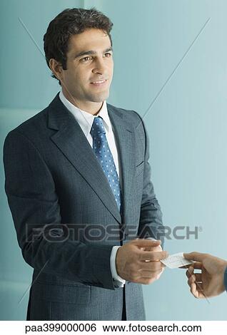 Businessman handing second man business card View Large Photo Image Stock Photograph - Businessman handing second man business card. Fotosearch