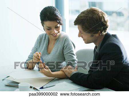 Young woman showing man in suit credit card, man touching woman's arm View Large Photo Image Stock Image - Young woman showing man in suit credit card, man touching woman's arm. Fotosearch