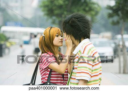 Teenage couple in urban setting, girl touching boy's face View Large Photo Image Stock Image - Teenage couple in urban setting, girl touching boy's face. Fotosearch