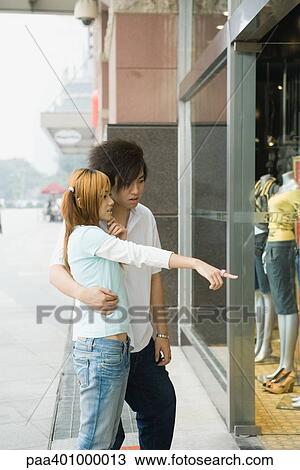 Teenage couple window shopping View Large Photo Image Stock Image - Teenage couple window shopping. Fotosearch