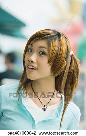 Teenage girl, looking at camera, portrait View Large Photo Image Stock Image - Teenage girl, looking at camera, portrait. Fotosearch
