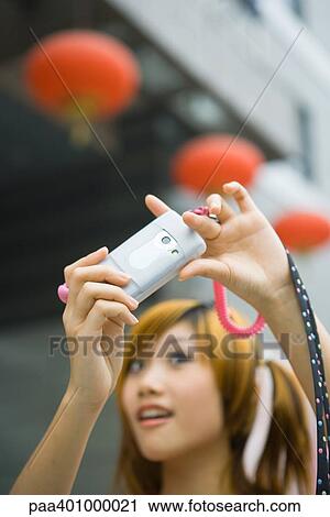 Teenage girl taking photo with cell phone View Large Photo Image Stock Image - Teenage girl taking photo with cell phone. Fotosearch