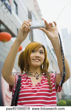 Teenage girl taking photo with cell phone View Large Photo Image Stock Photo - Teenage girl taking photo with cell phone. Fotosearch