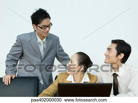 Stock Image - Business colleagues interacting. Fotosearch