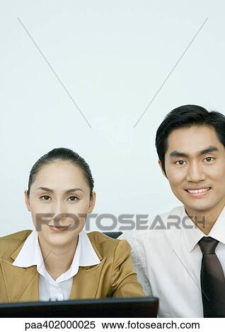 Businessman and businesswoman side by side, smiling at camera View Large Photo Image Stock Photography - Businessman and businesswoman side by side, smiling at camera. Fotosearch
