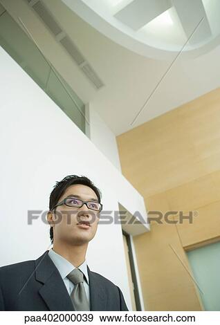 Businessman, head and shoulders, low angle view View Large Photo Image Stock Photo - Businessman, head and shoulders, low angle view. Fotosearch
