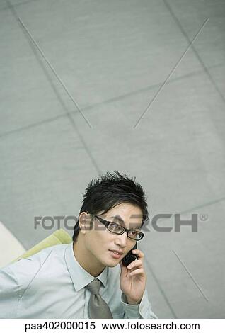 Businessman using cell phone View Large Photo Image Stock Photography - Businessman using cell phone. Fotosearch