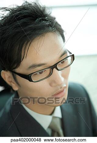 Businessman wearing glasses, close-up, high angle view View Large Photo Image Stock Photo - Businessman wearing glasses, close-up, high angle view. Fotosearch