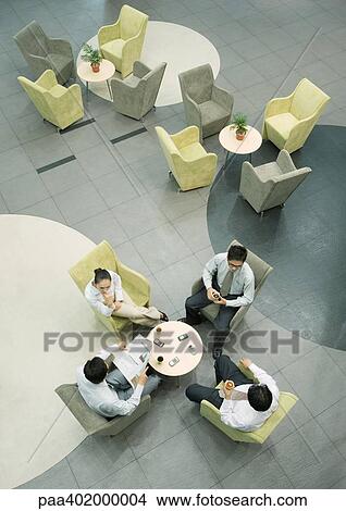 Picture - Executives sitting in lobby. Fotosearch