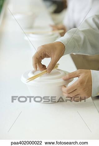 Man picking up chopsticks on take-out food container, cropped view View Large Photo Image Stock Image - Man picking up chopsticks on take-out food container, cropped view. Fotosearch