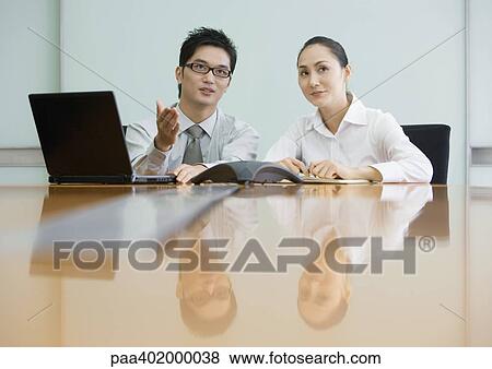 Two business executives working in conference room View Large Photo Image Stock Photo - Two business executives working in conference room. Fotosearch