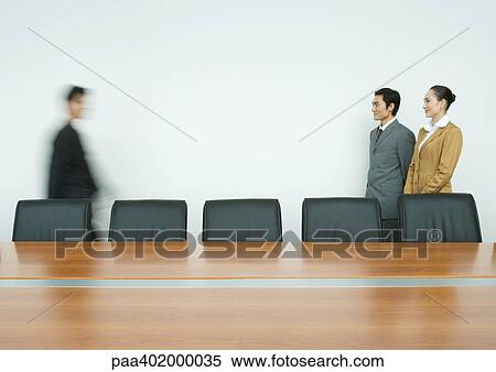 Two business partners greeting associate in conference room View Large Photo Image Stock Photography - Two business partners greeting associate in conference room. Fotosearch