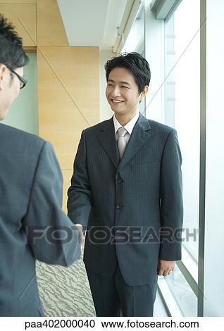 Two businessmen shaking hands View Large Photo Image Stock Image - Two businessmen shaking hands. Fotosearch