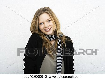 Teenage girl wearing scarf, smiling at camera View Large Photo Image Stock Image - Teenage girl wearing scarf, smiling at camera. Fotosearch