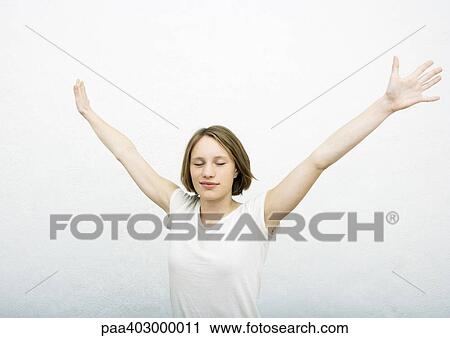 Teenage girl with arms out, eyes closed View Large Photo Image Stock Image - Teenage girl with arms out, eyes closed. Fotosearch